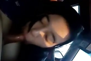 Asian gives blowjob in a car