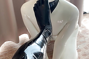 White rubber doll licks toes